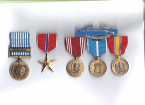 Medals left to right: Korea, For service in defence of the principles of the charter of the United Nations; Bronze Star for meritorious achievement; "Efficiency, Honor, Fidelity" for Good Conduct; Korean Service USA; National Defense. Above: Combat Infantryman's Badge, awarded to persons under enemy fire, "a very prestigious award." 
